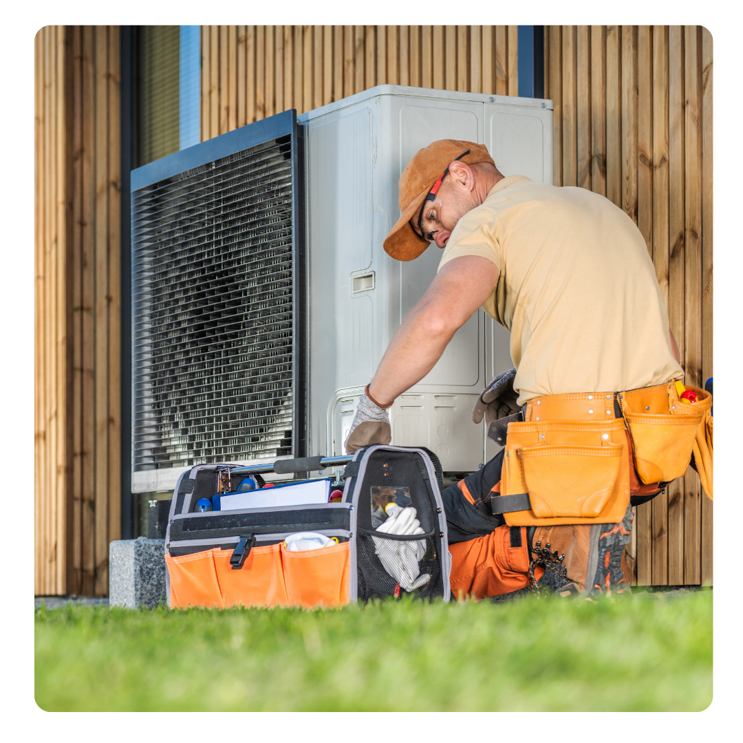 Technician repairing heat pump - heat pump repair call out